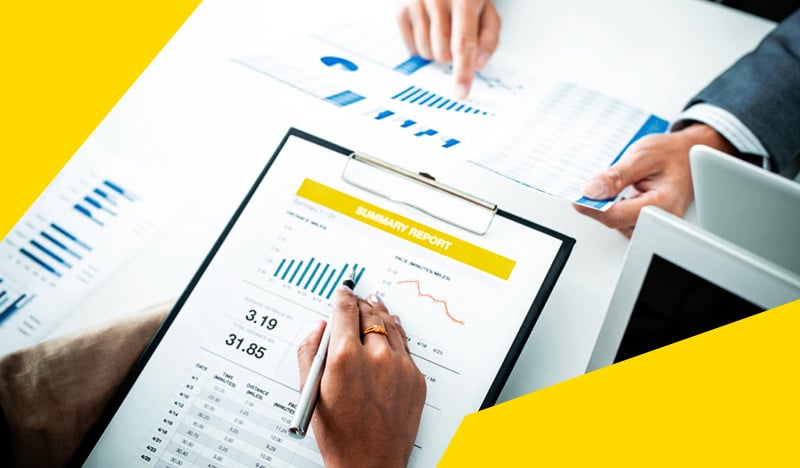 Business summary report with charts and data analysis on clipboard