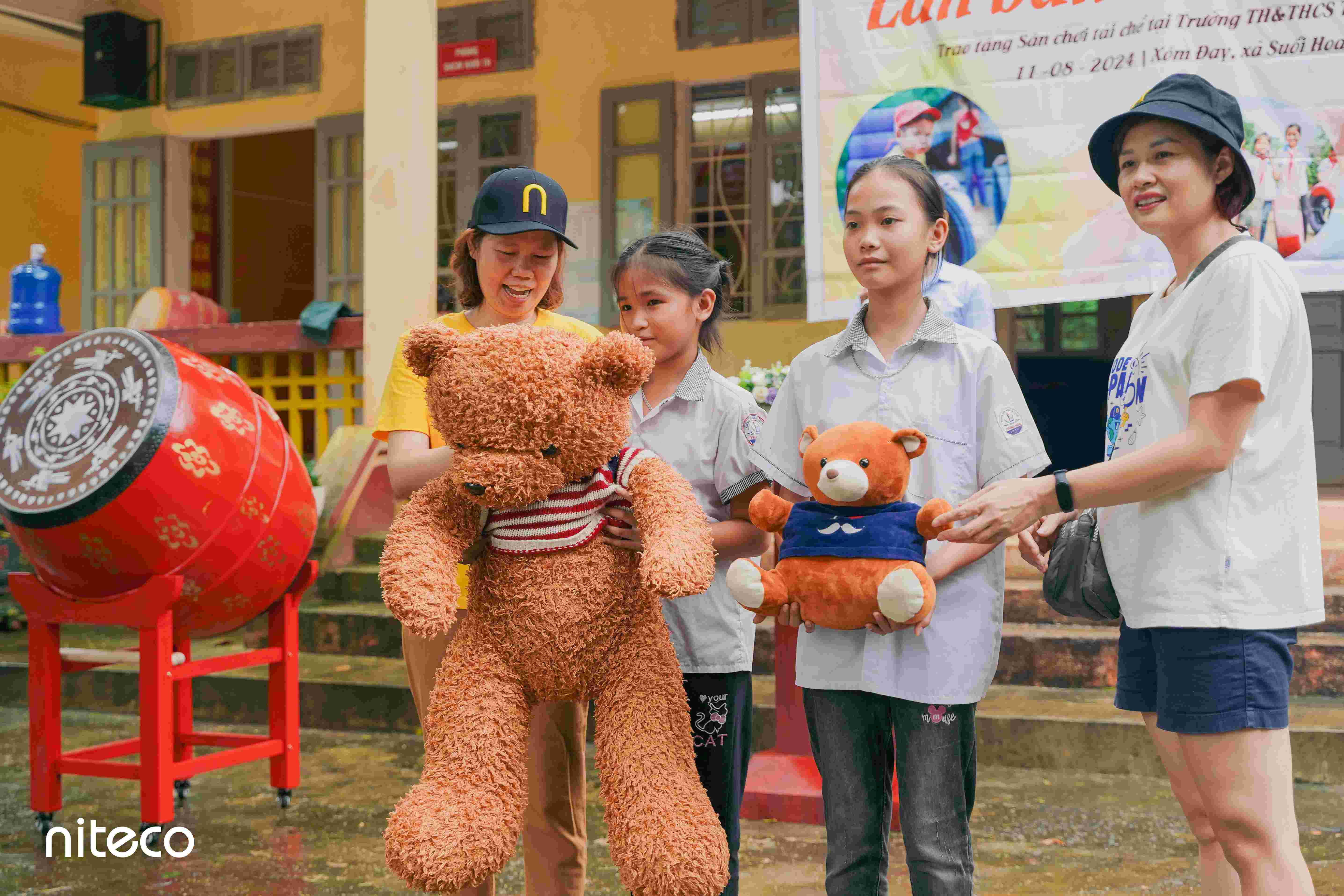Children with teddy bears during community support event at local school