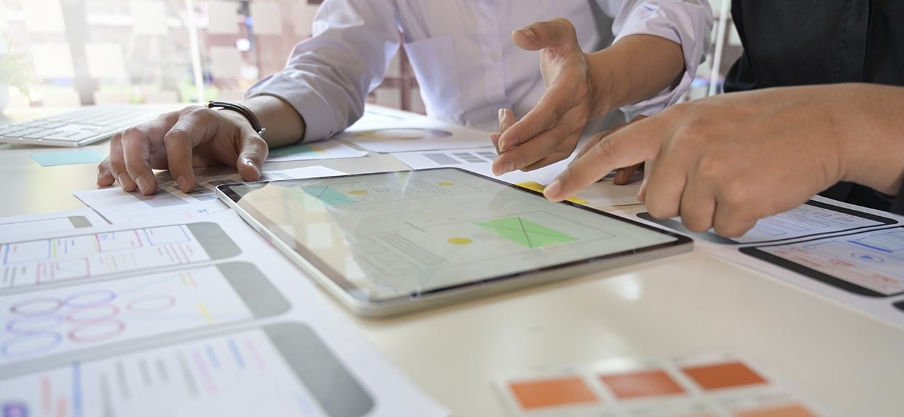 Collaborative UX design process with wireframes and tablet prototyping session