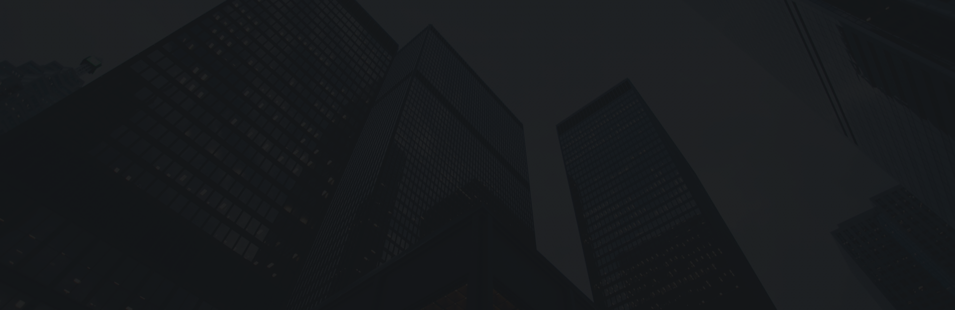 Testimonial Skyscraper office buildings under dark night sky in urban business district