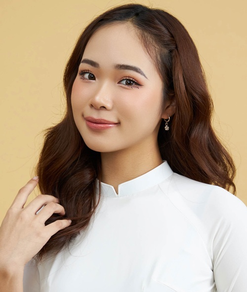 Young woman with radiant skin and natural makeup in white outfit