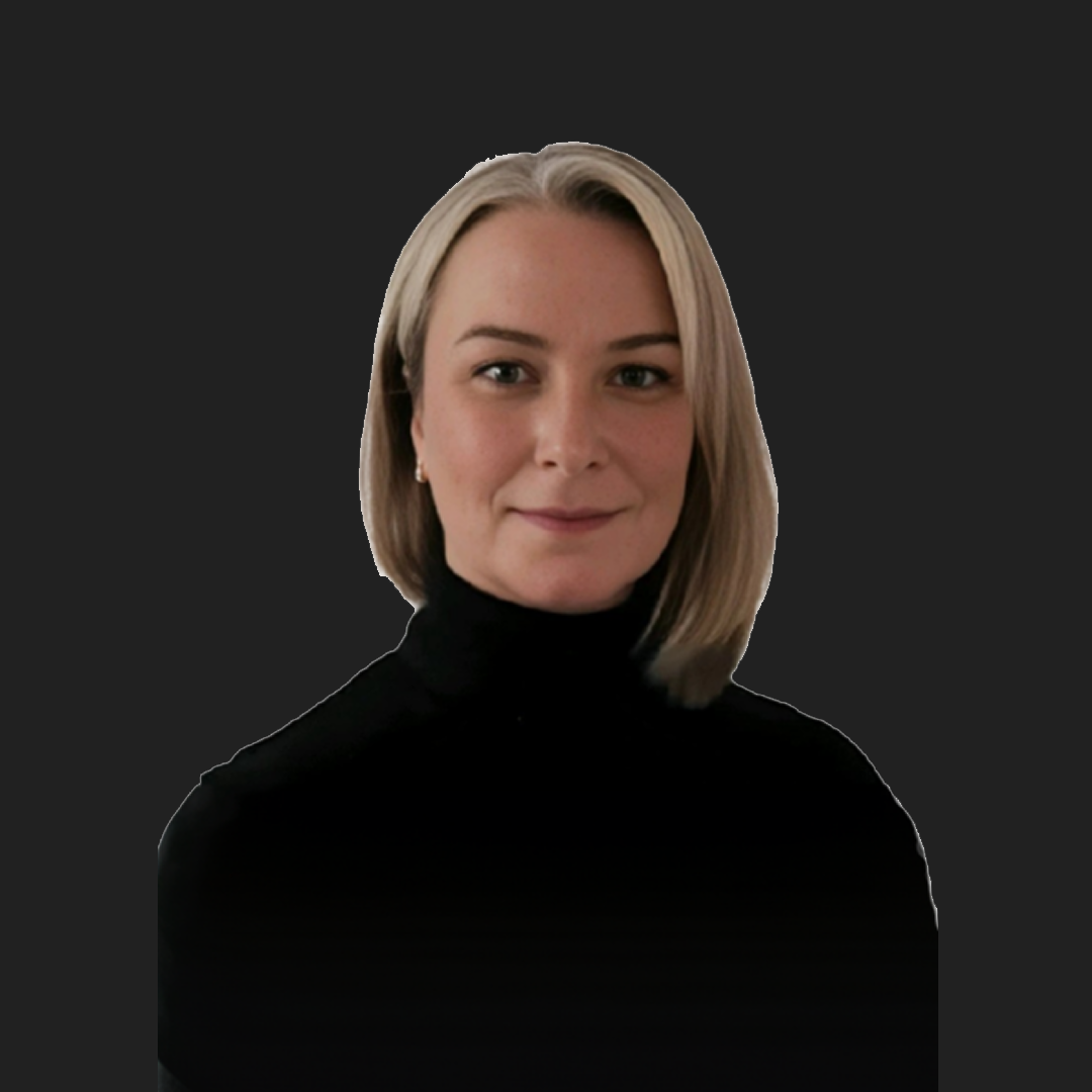 Blonde woman with bob haircut wearing black turtleneck against dark background