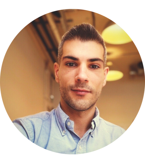 Young professional man in light blue shirt with modern haircut indoors