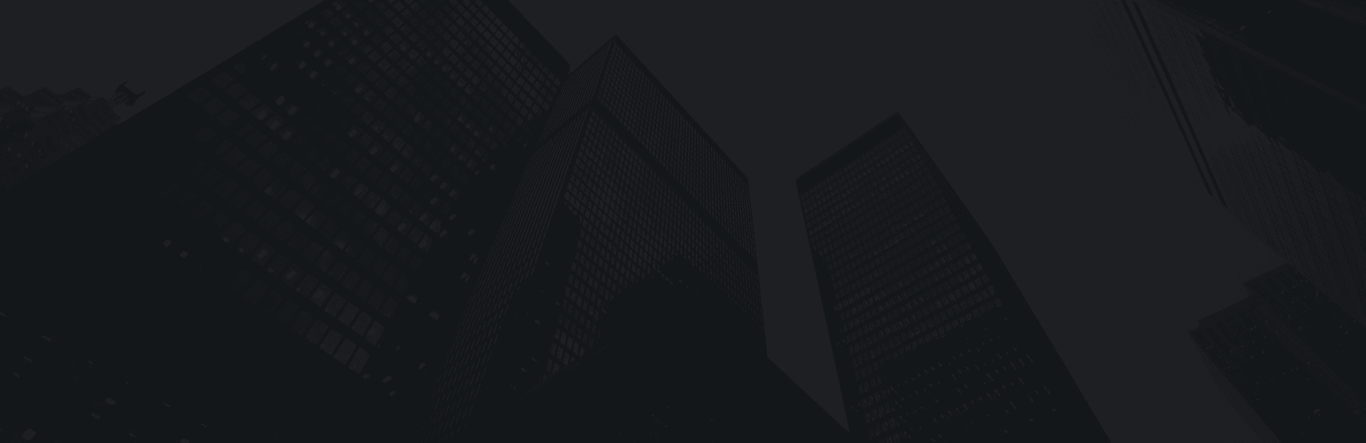 Skyscrapers towering against a dark sky in urban cityscape background