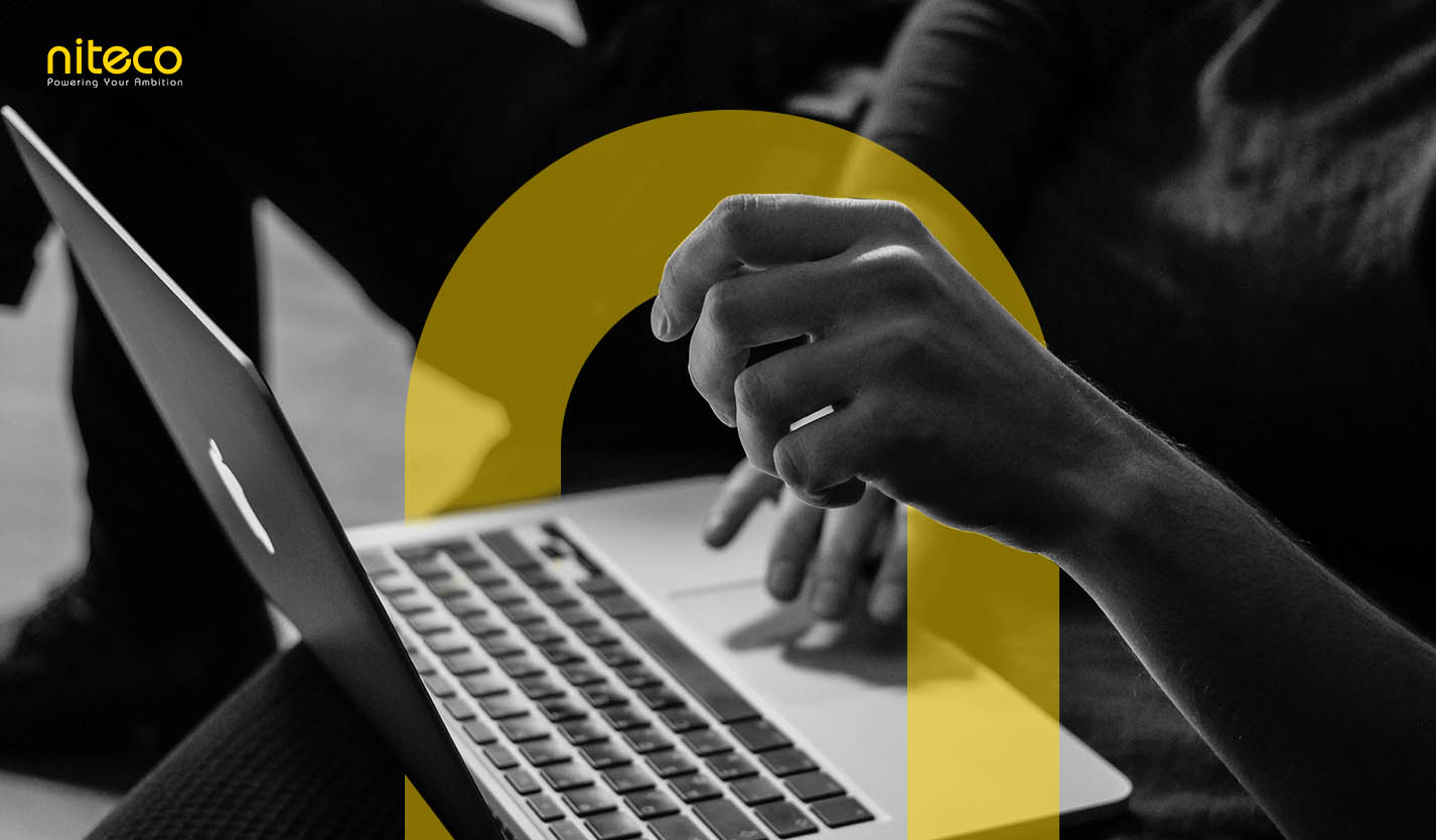 Niteco team collaborating on laptop to power your ambition and innovation