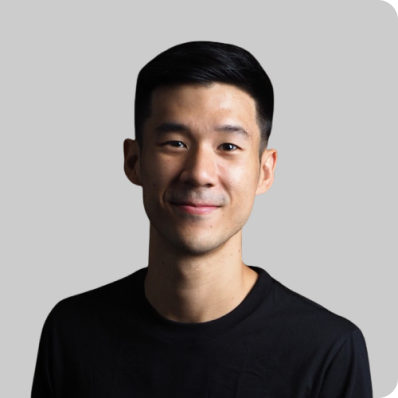 Portrait of a young Asian man with short hair wearing a black shirt