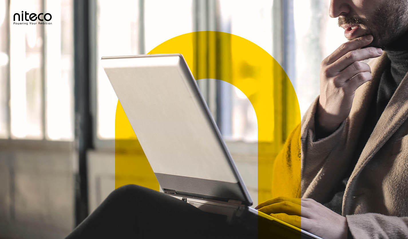 Man using laptop with Niteco logo and branding for digital ambition