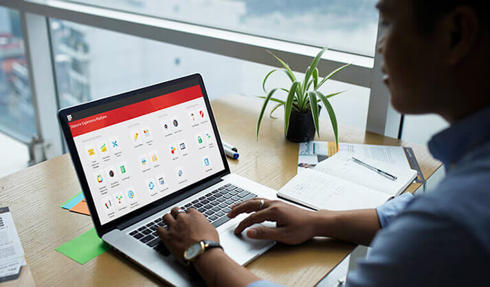 Person using a laptop with Microsoft Power Platform dashboard on screen