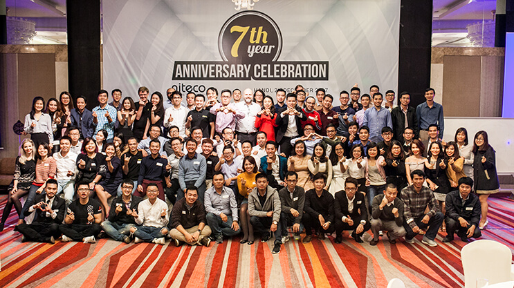 Aiteco team celebrating 7th year anniversary with group photo and smiles