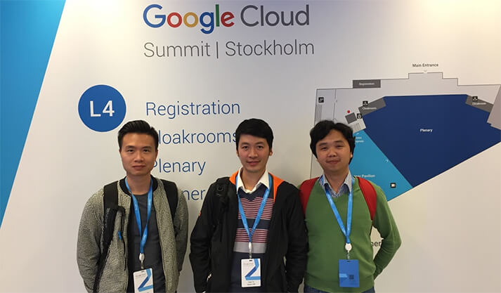 Three attendees wearing badges at Google Cloud Summit Stockholm registration area