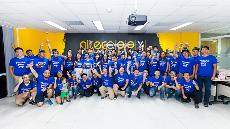 Team Nitegatex posing in the office wearing matching blue Passion Human Help t-shirts