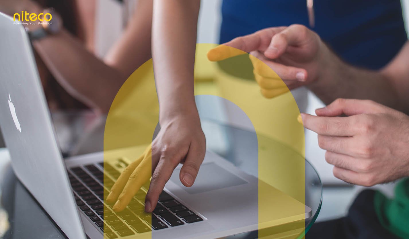 Hands collaborating on laptop keyboard, teamwork and innovation at Niteco